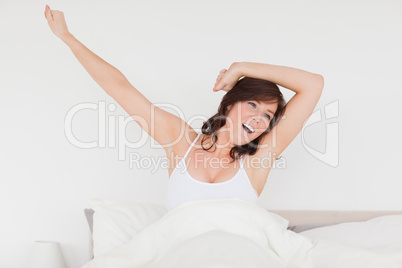 Good looking brunette woman posing while stretching