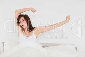 Charming brunette woman posing while stretching