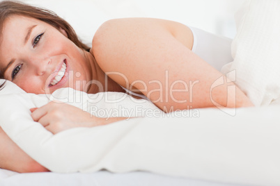 Charming brunette woman posing while lying