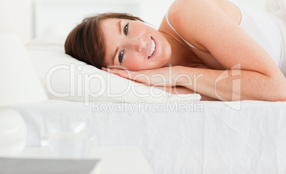 Gorgeous brunette female posing while lying