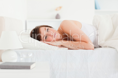 Lovely brunette female thinking while lying