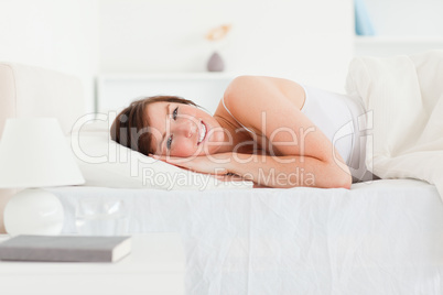 Lovely brunette female posing while lying