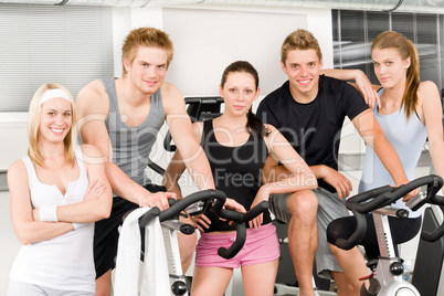 Fitness young group people at gym bicycle