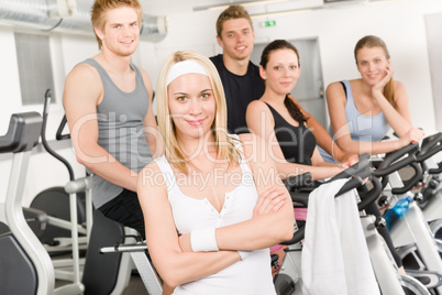 Fitness young group people at gym bicycle