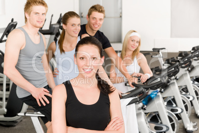 Fitness young group people at gym bicycle