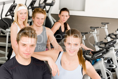 Fitness young group people at gym bicycle