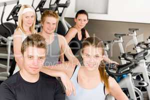 Fitness young group people at gym bicycle