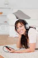 Beautiful brunette female listening to music with her mp3 player