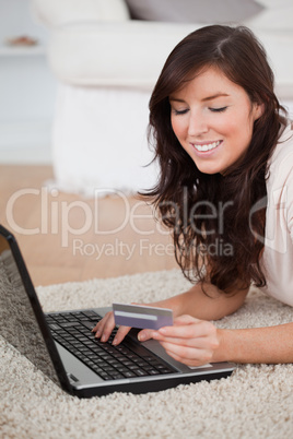 Young beautiful woman making a payment with a credit card on the