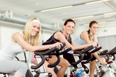 Fitness young woman on gym bike spinning