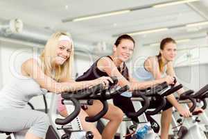 Fitness young woman on gym bike spinning