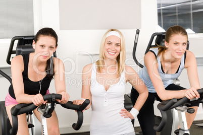 Fitness young girls spinning at gym posing