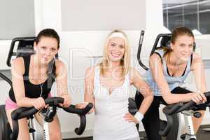 Fitness young girls spinning at gym posing