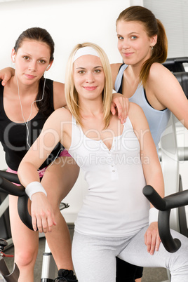 Fitness young girls spinning at gym posing