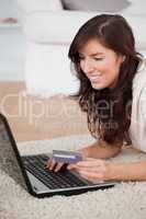 Young attractive woman making a payment with a credit card on th