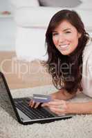 Young good looking woman making a payment with a credit card on