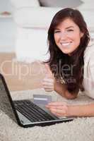 Young pretty woman making a payment with a credit card on the in