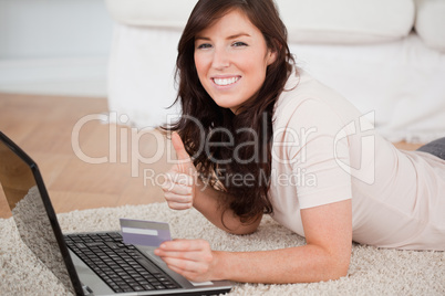 Young gorgeous woman making a payment with a credit card on the