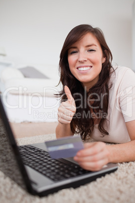 Young charming woman making a payment with a credit card on the
