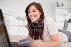Young charming female making a payment with a credit card on the