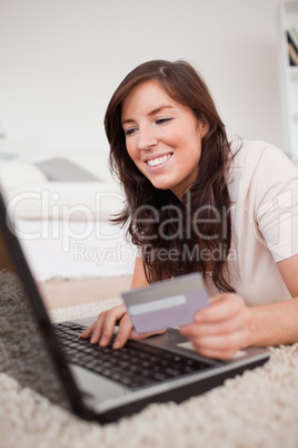 Young beautiful female making a payment with a credit card on th