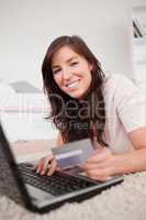 Young attractive female making a payment with a credit card on t