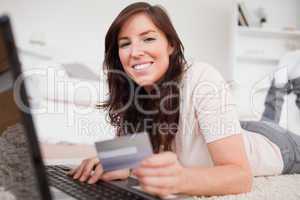 Young good looking female making a payment with a credit card on