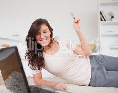 Young pretty female making a payment with a credit card on the i