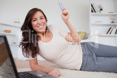 Good looking brunette female making a payment with a credit card