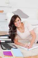 Young gorgeous woman relaxing with her laptop while writing on a