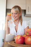 young blond woman with a glass of juice