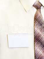 blank badge pinned to his shirt