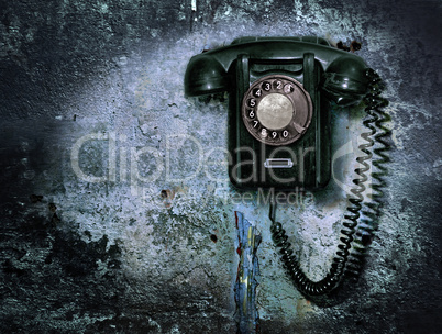 Old phone on the destroyed wall