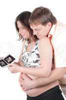 Couple holding a sonogram of their child