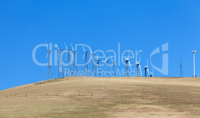 Set of windmills on the cornfield with blue sky