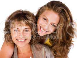 Close-up of smiling elder mum and daughter