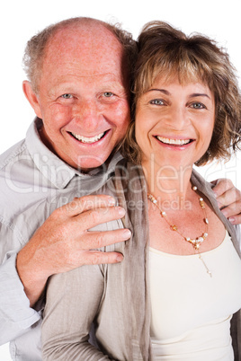 Affectionate old man hugging his wife from behind
