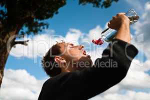 Sportsman drinking water after training