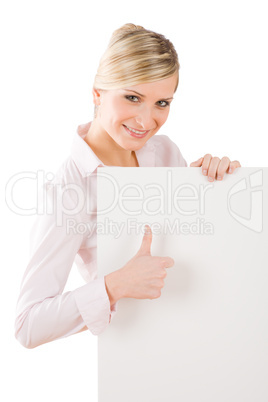 Happy businesswoman behind empty banner thumbs up