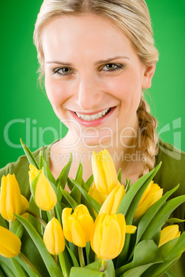 Young happy woman hold yellow tulips flower