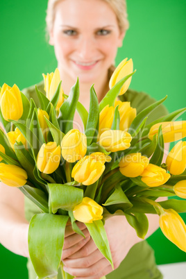 Young woman hold yellow tulips flower