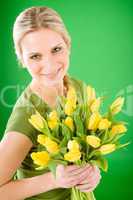 Young happy woman hold yellow tulips flower