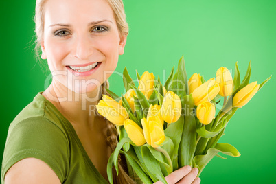 Young happy woman hold yellow tulips flower