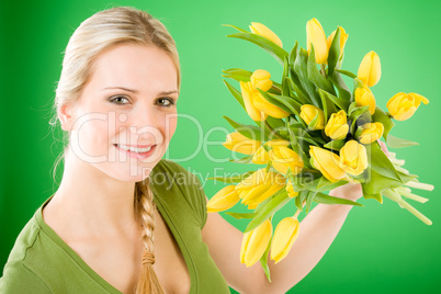 Young woman hold yellow tulips flower