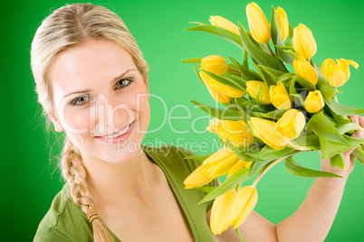 Young happy woman hold yellow tulips flower