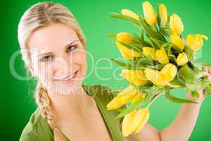 Young happy woman hold yellow tulips flower