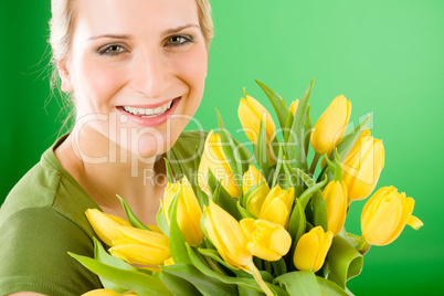 Young happy woman hold yellow tulips flower