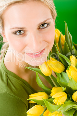 Young happy woman hold yellow tulips flower