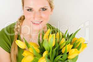 Young woman hold yellow tulips flower