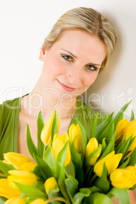 Young woman hold yellow tulips flower